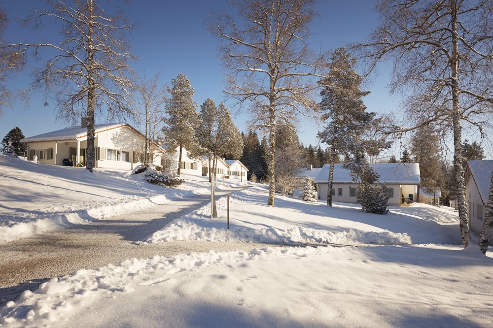 Exterior view in winter - Reka Holiday Village Montfaucon reka-holiday-village, western-switzerland, montfaucon Exterior view in winter - Reka Holiday Village Montfaucon reka-holiday-village, western-switzerland, montfaucon