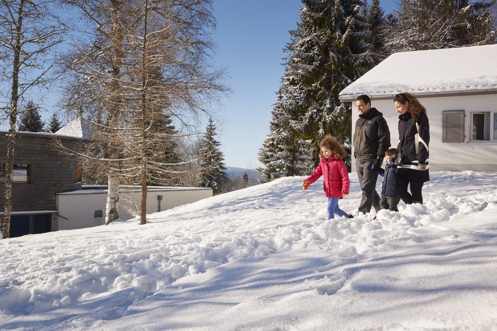 Exterior view in winter - Reka Holiday Village Montfaucon reka-holiday-village, montfaucon, western-switzerland Exterior view in winter - Reka Holiday Village Montfaucon reka-holiday-village, montfaucon, western-switzerland
