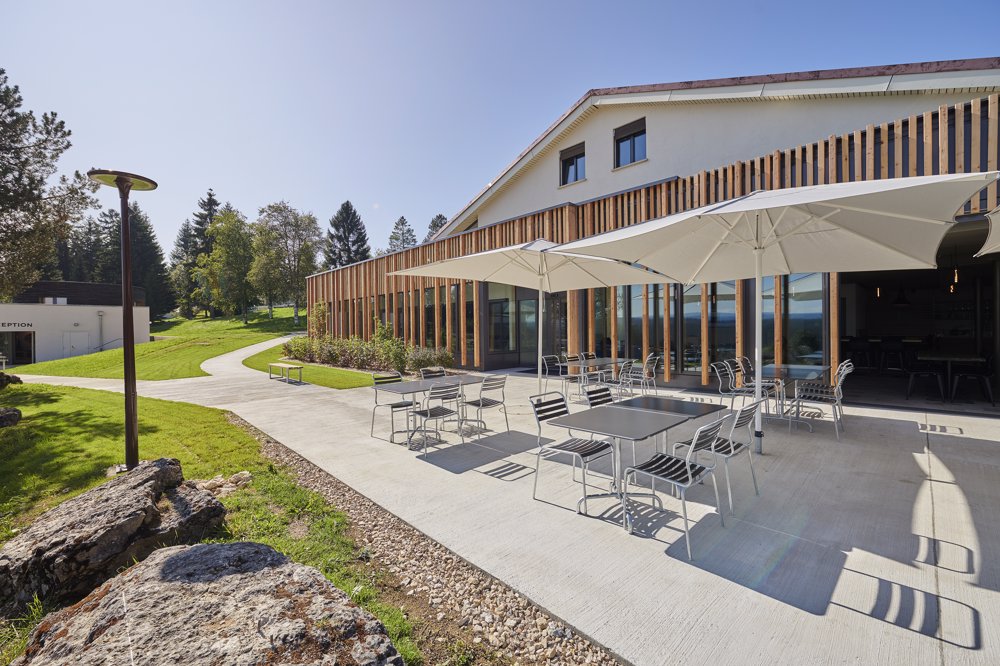 Exterior view in summer - Reka Holiday Village Montfaucon montfaucon, reka-holiday-village, western-switzerland Exterior view in summer - Reka Holiday Village Montfaucon montfaucon, reka-holiday-village, western-switzerland