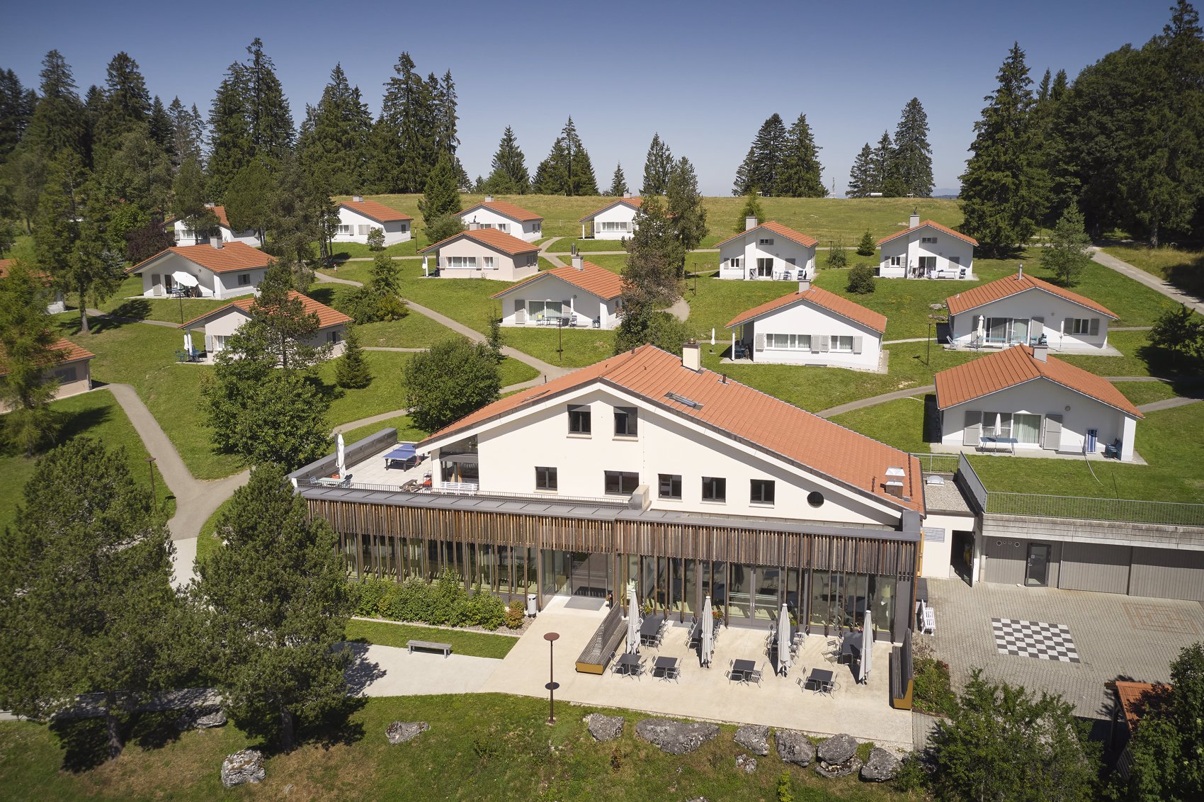 Exterior view in summer - Reka Holiday Village Montfaucon montfaucon, western-switzerland, reka-holiday-village Exterior view in summer - Reka Holiday Village Montfaucon montfaucon, western-switzerland, reka-holiday-village