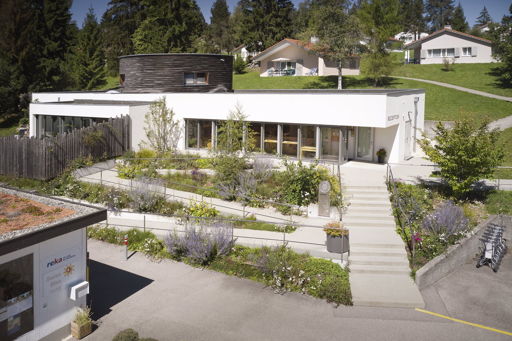 Exterior view in summer - Reka Holiday Village Montfaucon montfaucon, reka-holiday-village, western-switzerland Exterior view in summer - Reka Holiday Village Montfaucon montfaucon, reka-holiday-village, western-switzerland