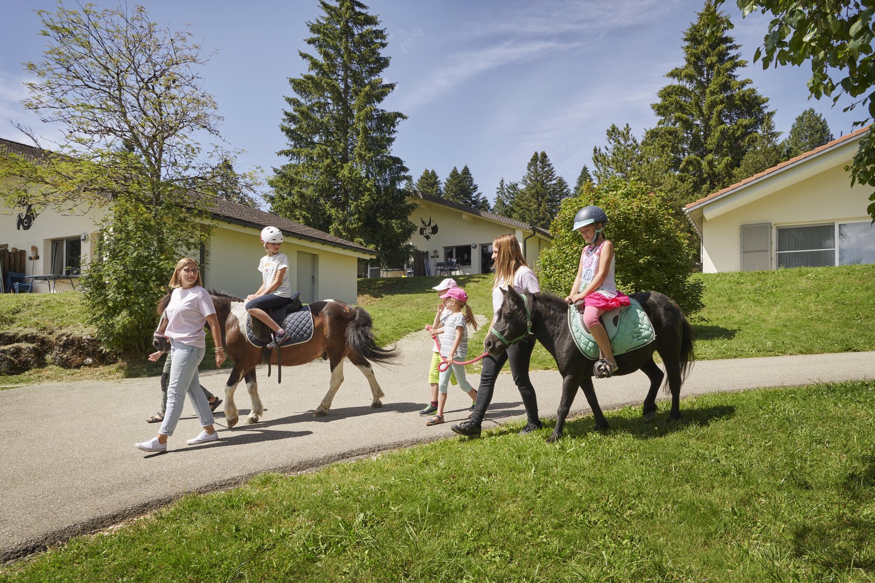Exterior view in summer - Reka Holiday Village Montfaucon western-switzerland, montfaucon, reka-holiday-village Exterior view in summer - Reka Holiday Village Montfaucon western-switzerland, montfaucon, reka-holiday-village